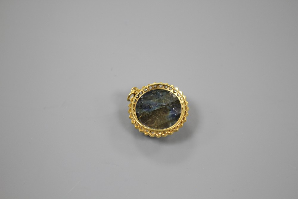 A 20th century yellow metal, diamond and carved labradorite? moon face pendant, 26mm, gross weight 7.2 grams.